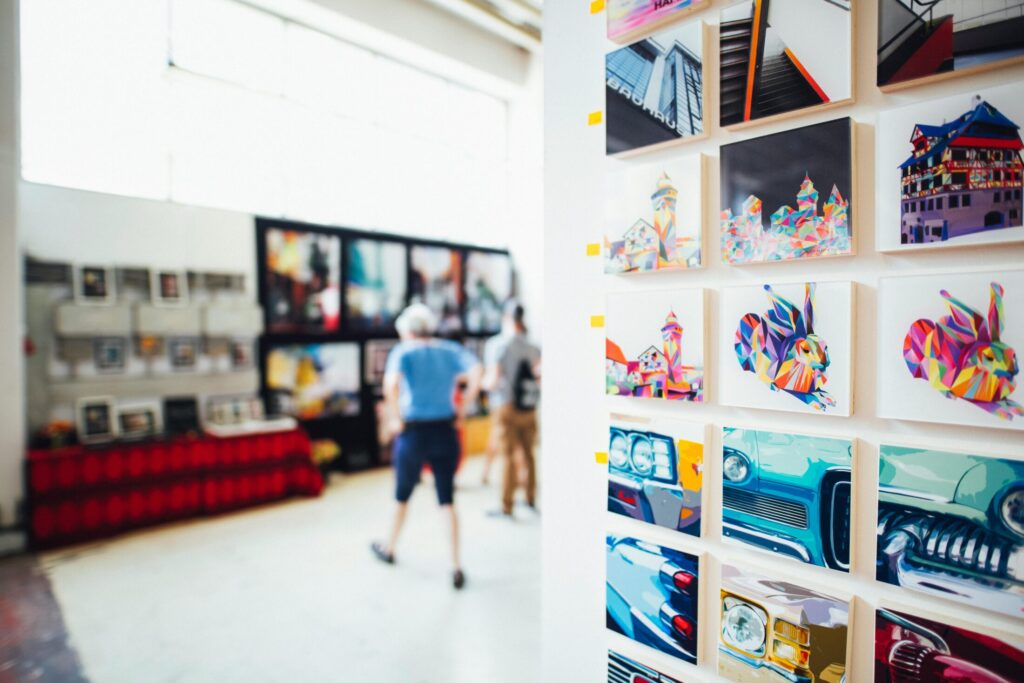 a bunch of paintings on a white wall
