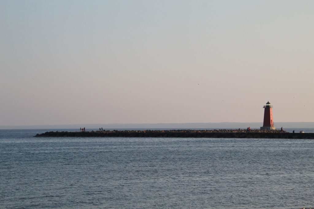 scenic view of a lighthouse on a tranquil seaside breakwater